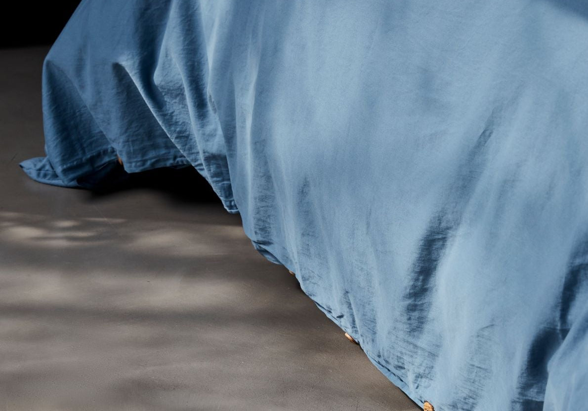 Bed dressed in organic cotton bedding under soft natural morning light — sleep statistics 2026