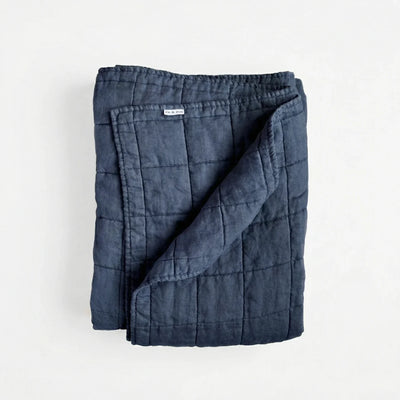Best linen quilts 2026 — Or & Zon stonewashed French flax linen quilt in navy blue on a queen bed