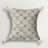 Decorative pillow with black geometric pattern on a light gray background