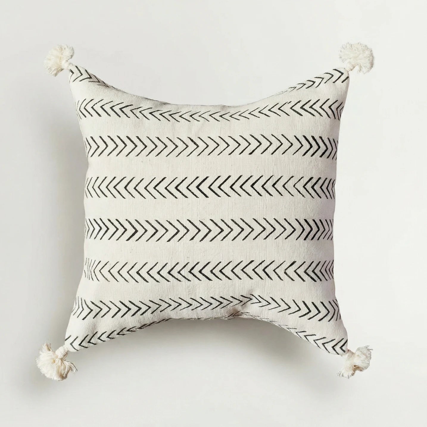 Decorative pillow with black arrow pattern on a white background