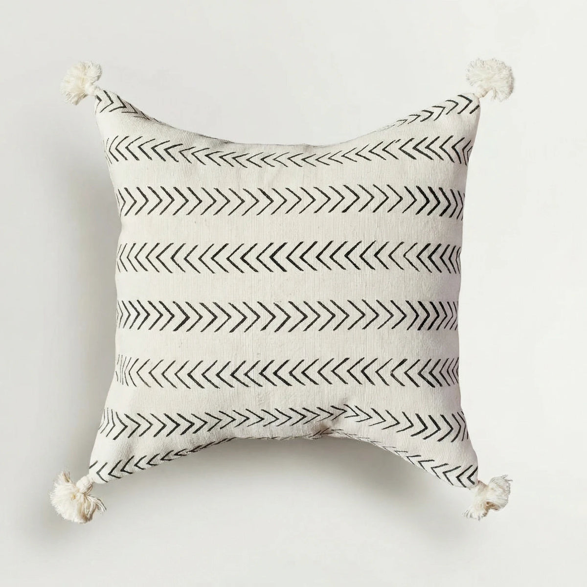 Decorative pillow with black arrow pattern on a white background