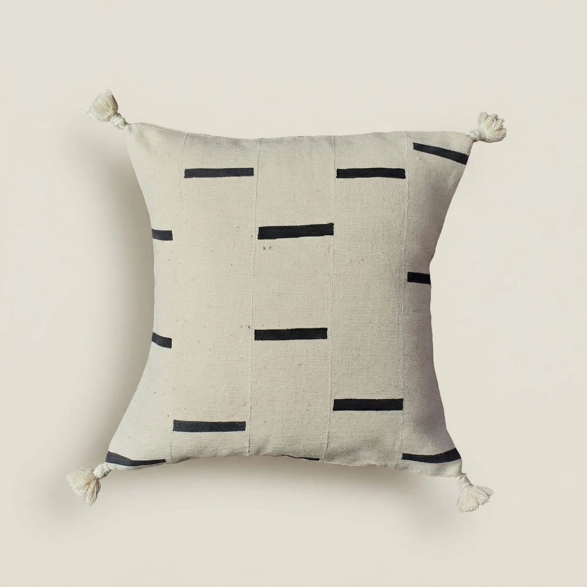 Decorative pillow with black line pattern on a beige background