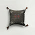 Decorative pillow with embroidered patterns on a light gray background