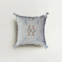 Decorative pillow with embroidered patterns on a light background