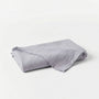 Folded gray blanket on a white background
