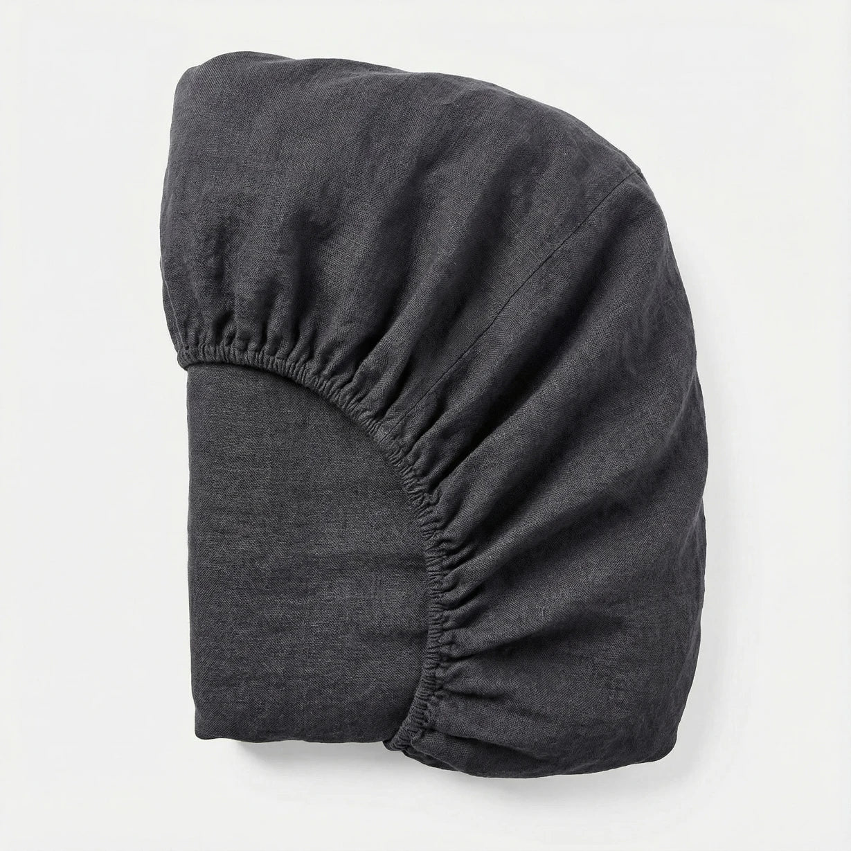 Dark gray fabric headband on a light gray background